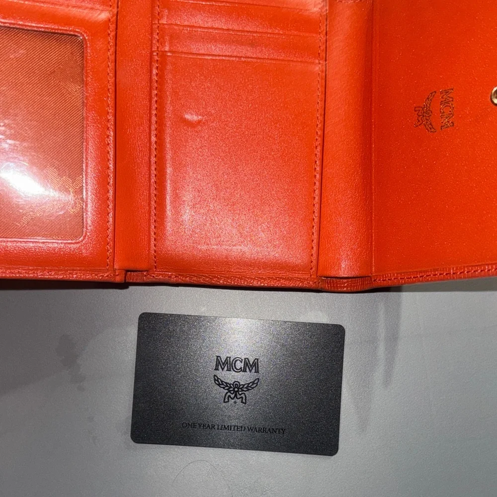 MCM Orange Leather Trifold Wallet with Gold Logo Accents